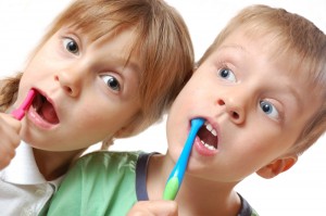 mother and daughter brushing their teeth