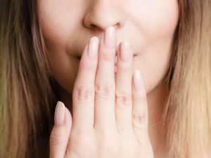 Woman with Chipped Tooth is Hiding it with Her Hand