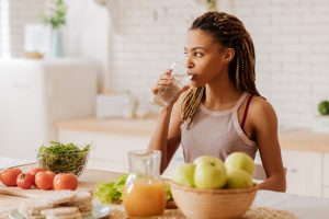 woman drinking water fighting dry mouth